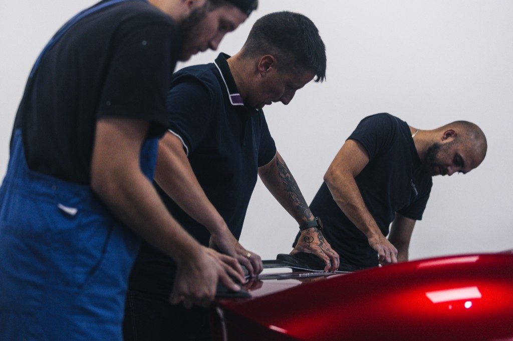 AT26 Design team working on carbon fiber parts for a sports car